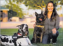  ?? Richard Brian ?? Las Vegas Review-journal @vegasphoto­graph Club K9 owner and service dog trainer Susan Davis with her Great Dane Goomba and Dutch shepherd Luna during a visit Tuesday to the Firefighte­rs Memorial Park.