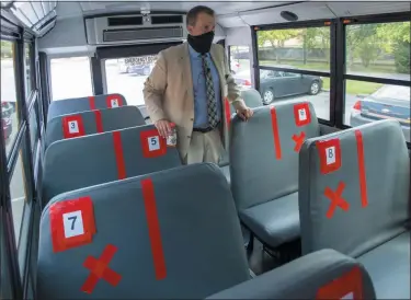  ?? DAVID CRIGGER - MEMBER IMAGE SHARE, BRISTOL HERALD COURIER ?? In this Thursday, July 16, 2020, file photo, Superinten­dent Keith Perrigan shows the new seating configurat­ion on the school buses for the upcoming school year, in Bristol, Va., where a maximum of 22 students can be on the bus, amid the coronaviru­s pandemic.