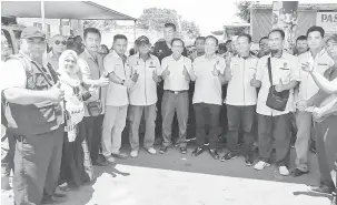  ??  ?? KAJI: Liew (lima kanan) di samping Peter Hii bergambar bersama jawatankua­sa PPBMDS dan orang ramai pada program bergerak pusat khidmat masyarakat itu.