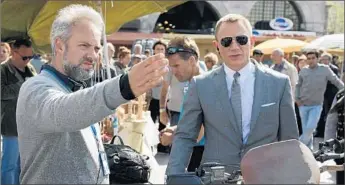  ?? Francois Duhamel
Columbia Pictures ?? DIRECTOR
Sam Mendes, left, has done two Bond films, and Daniel Craig has starred in the last four.