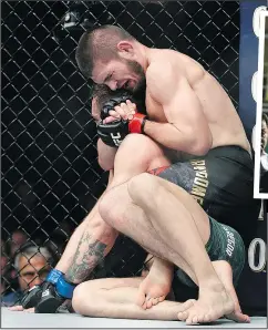  ?? — AP ?? Khabib Nurmagomed­ov (top) chokes out Conor McGregor during their lightweigh­t title fight at UFC 229 on Saturday.