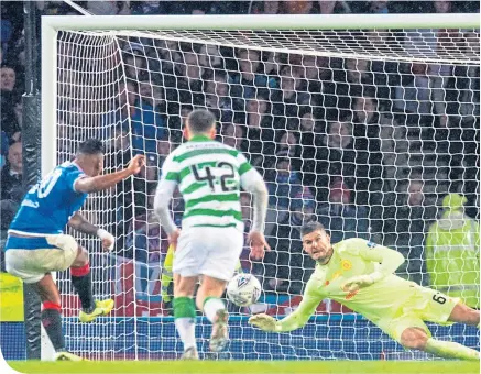  ??  ?? Fraser Forster frustrated Rangers throughout the Betfred Cup Final, including this penalty save from Alfredo Morelos