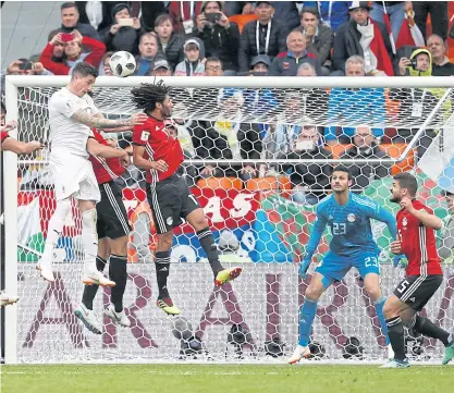  ??  ?? Uruguay defender Jose Gimenez, left, heads the ball to score the winner against Egypt.