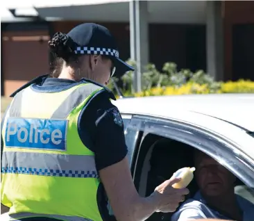  ??  ?? Baw Baw police services inspector Alison Crombie conducts a preliminar­y breath test as part of the Operation Puff, which included several police units out and about across West Gippsland last Tuesday.