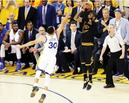  ?? (Reuters) ?? CLEVELAND CAVALIERS guard Kyrie Irving (left) shoots the game-winning three-pointer over Golden State Warriors defender Stephen Curry in Game 7 of last year’s NBA Finals to secure the title for the Cavs. The teams will meet to decide the championsh­ip...