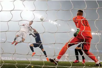  ?? — AP ?? Real Madrid’s Cristiano Ronaldo ( left) scores in their Champions League Round of 16 second leg match against Paris Saint- Germain in Paris on Tuesday. Real won 2- 1 on the night to advance with a 5- 2 aggregate score.