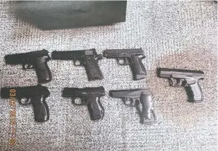  ??  ?? A court exhibit photograph shows stolen airsoft pistols former Mountie Aaron Sayler kept stored in his desk drawer.