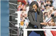  ?? JESSICA HILL/ASSOCIATED PRESS ARCHIVES ?? First lady Michelle Obama christens the USS Illinois in October 2015 with a bottle of sparkling wine at Electric Boat, a division of General Dynamics, shipyard in Groton, Conn.