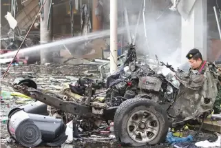  ??  ?? military personnel inspects the site of a bomb attack at a supermarke­t in the city of Pattani on Tuesday. (Reuters)