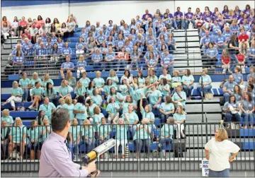  ?? John Popham ?? Assistant Superinten­dent John Parker fires a T-shirt cannon into a crowd of Johnson Elementary School teachers who dive to catch the prize. The shirt has the new FCS logo on it which was revealed during the school system’s Kickoff Classic.