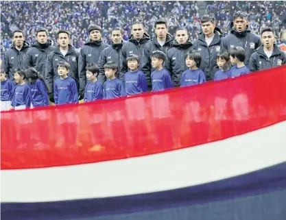  ??  ?? Thailand players sing their national anthem before their match against Japan in Saitama on Tuesday.