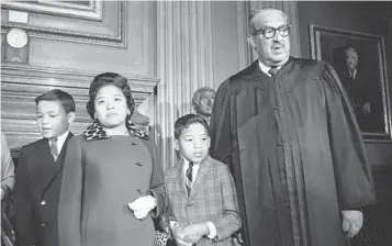  ?? HENRY GRIFFIN AP ?? Supreme Court Justice Thurgood Marshall (right) stands with his family — son Thurgood Jr., wife Cecilia, and son John — before taking his seat at the court for the first time in 1967. Cecilia Marshall died Tuesday.