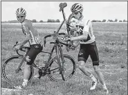  ?? AP/JEFF PACHOUD ?? Four-time champion Chris Froome (right) and Jasper De Buyst get back on the road after crashing Saturday in the first stage of the Tour de France. Froome finished the stage in 91st place.