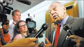  ?? Jacquelyn Martin ?? The Associated Press Sen. Chuck Grassley, R-iowa, right, answers questions about allegation­s against Supreme Court nominee Brett Kavanaugh as he arrives for a Senate Finance Committee hearing Wednesday on Capitol Hill.