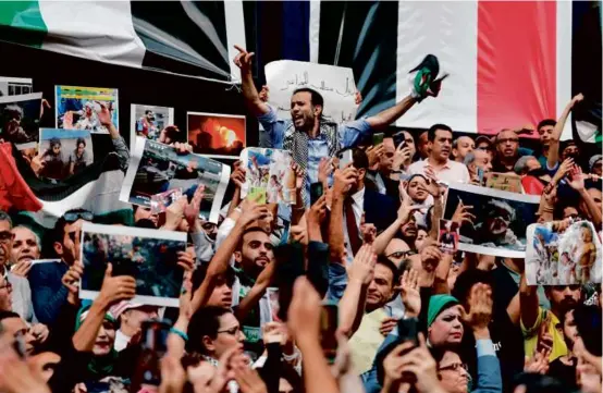  ?? KHALED DESOUKI/AFP VIA GETTY IMAGES ?? Egyptians shouted slogans and waved national flags as they protested a strike on a Gaza hospital, in Cairo on Wednesday.