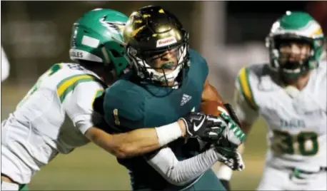  ?? WADE PAYNE — KNOXVILLE NEWS SENTINEL VIA AP ?? Knoxville Catholic’s Dashon Bussell is hit by Rhea County’s Reece Cooley, left, during a high school game in Knoxville, Tenn. Bussell says he has not decided whether he plans to sign with his school in December or wait until February. The Western Michigan-bound receiver likes having the option. The high school senior has that choice thanks to a new set of NCAA recruiting rules that took effect this year.