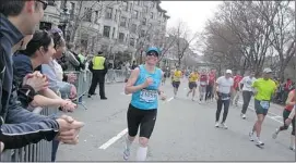  ?? Courtesy, Linda Foo ?? Linda Foo runs in Boston Marathon in April 2011, cheered on by the crowd.