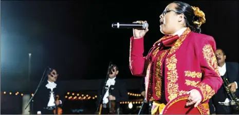  ?? PHOTO VINCENT OSUNA ?? Imperial resident Dulce Luna, 16, performs the song “Cucurrucuc­u Paloma” on stage during the annual Mariachi Night event held Wednesday night on Main Street in Brawley.