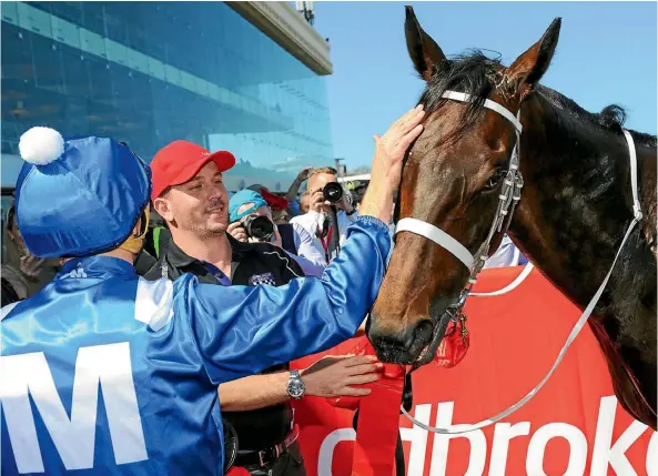  ?? PHOTO: GETTY IMAGES ?? Jockey Hugh Bowman gives Winx a nod and a pat after the pair combined to win the Caulfield WFA Stales yesterday. It was the champion mare’s 16th win in 22 starts.