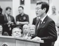  ??  ?? Satoru Kasuya, managing officer and deputy chief officer of Aisin AW, addresses a meeting at Cibolo City Hall.