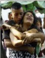  ?? JUAN CARLOS HERNANDEZ — THE ASSOCIATED PRESS ?? A relative of a prisoner is comforted while waiting to hear news about the fate of the detained prisoners at a police station where a riot broke out, in Valencia, Venezuela, Wednesday. In a state police station housing more than one hundred prisoners,...