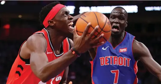  ?? GREGORY SHAMUS/GETTY IMAGES ?? Raptors forward Pascal Siakam tries to drive around Thon Maker of the Pistons during a 112-107 OT Pistons win at Little Caesars Arena on Sunday in Detroit.