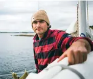  ??  ?? Right: Synnott’s sailboat called CamelotBel­ow: Elias poses during a small weather break from the fog