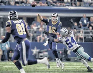  ?? Robert Gauthier Los Angeles Times ?? JARED GOFF gets off a pass ahead of Dallas linebacker Jaylon Smith during the first half of the Rams’ 35-30 victory over the Cowboys. Goff completed 21 of 36 passes for 255 yards and two touchdowns.