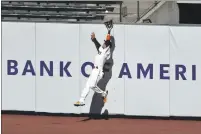  ??  ?? The Giants’ Wilmer Flores makes a leaping catch at the wall on a ball hit by the Rockies’ Charlie Blackmon during the fifth inning on Thursday in San Francisco.