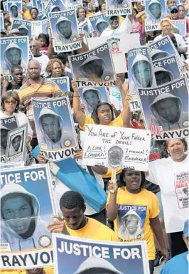  ?? GARY W. GREEN/ORLANDO SENTINEL ?? Thousands of demonstrat­ors march along West 13th Street in Sanford during a NAACP rally and march demanding justice in the shooting of Trayvon Martin on March 31, 2012.