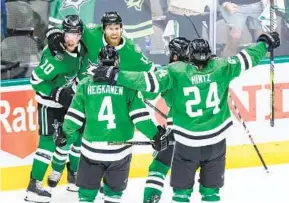  ?? GARETH PATTERSON AP ?? Dallas Stars, including Ty Dellandrea (10), Miro Heiskanen (4) and Roope Hintz (24) celebrate with Joe Pavelski (16) after his overtime goal against Vegas Golden Knights.