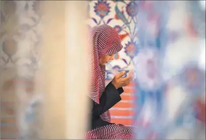  ??  ?? Downcast: A woman prays at the Nizamiye Masjid in Midrand. Despite the rainbow nation’s liberal values, the rights of Muslim women are elided in South African marriage law. Photo: Daniel Born/Gallo Images/The Times