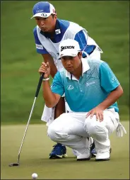  ?? JEFF SINER/TRIBUNE NEWS SERVICE ?? Hideki Matsuyama, right, and his caddie, Daisuke Shindo line up a putt on the 18th green during the second round of the PGA Championsh­ip on Friday in Charlotte, N.C.