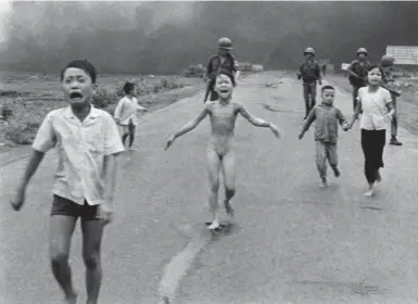  ?? NICK UT/THE ASSOCIATED PRESS FILE PHOTO ?? JUNE 8, 1972 Crying children, including 9-year-old Kim Phuc, centre, run down a road near Trang Bang, Vietnam after an aerial napalm strike. Phuc was honoured Friday on the 40th anniversar­y of the photo that made her famous.