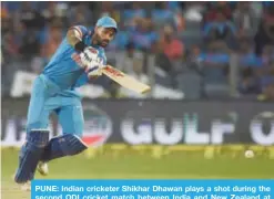  ?? —AFP ?? PUNE: Indian cricketer Shikhar Dhawan plays a shot during the second ODI cricket match between India and New Zealand at The Maharashtr­a Cricket Associatio­n Stadium in Pune.