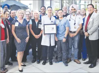  ??  ?? Members of Adventist Health and Rideout’s Stroke Program and the American Heart Associatio­n pose for a picture during an award ceremony at the Marysville hospital’s café on Aug. 7.