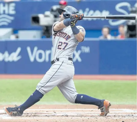  ?? CHRIS YOUNG/THE CANADIAN PRESS ?? Houston Astros’ Jose Altuve watches the flight of the ball after hitting a two-run home run off Toronto Blue Jays starting pitcher J.A. Happ (not shown) during second inning MLB baseball action, in Toronto, on Sunday.