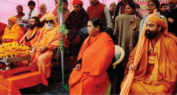  ?? — PTI ?? A file photo of then Union water resources minister Uma Bharati with Shankarach­arya Vasudevana­nd Saraswati and other sadhus during a campaign to save River Ganga at Magh Mela in Allahabad.