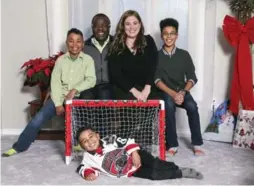  ?? ANDREW FRANCIS WALLACE/TORONTO STAR ?? Pearson Mbonda poses in front of a mini-hockey net this month with brothers Myers, 9, left, and Griffen, 12, father Al and mother Paula at their Pickering home.