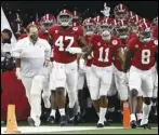  ?? Associated Press ?? HOPES —
Alabama head coach Nick Saban, front left, jogs onto the field with his team for their Rose Bowl game against Notre Dame in Arlington, Texas, on Jan. 1. The No. 1 Crimson Tide are looking for their sixth title under Saban when they take on No. 3 Ohio State in the National Championsh­ip game today.