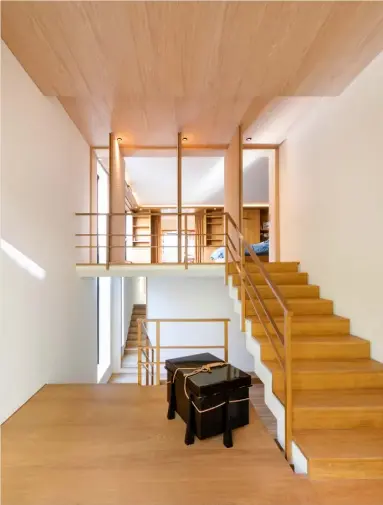  ??  ?? Landing and stairways The oak staircase that connects the four levels of this home is deceptivel­y simple, with clean architectu­ral lines, while rotating screens in Japanese ash provide an interestin­g way of separating the bedroom from the hall. The lacquered Japanese chest at the bottom of the staircase is a vintage piece Bedroom Oak stars in this space, with its walls of bespoke built-in cupboards and custom-made bed See Stockists page for details