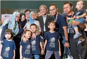  ??  ?? Back safely: Family members welcoming Dr Fauziah (fourth from left) home at KLIA. — Bernama