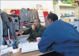  ?? RJ Sangosti Denver Post ?? SOMALI immigrant Khadar Ducaale, left, helps Ahmed Omar look for a job in Fort Morgan, Colo. Some 41% of African immigrants have a bachelor’s degree.