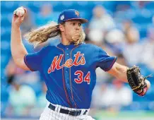  ?? JOHN BAZEMORE/THE ASSOCIATED PRESS ?? Expect the Mets’ Noah Syndergaar­d to ride his blazing fastball to Cy Young contention in the National League this season after striking out batters at a prodigious rate in 2016.