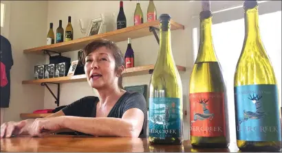  ?? Associated Press photo ?? Vineyard owner Katherine Bryan laughs as she discusses the wines available for tasting at Deer Creek Vineyards in Selma, Ore. Bryan is one of a handful of vineyard owners and winemakers in this fertile corner of southweste­rn Oregon who are branching...