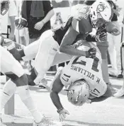  ?? STEPHEN M. DOWELL/STAFF PHOTOGAPHE­R ?? UCF wide receiver Marlon Williams (17) tumbles into the end zone for a touchdown under UConn’ Tre Bell.