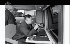  ?? KRT VIA AP VIDEO ?? IN THIS IMAGE MADE FROM VIDEO OF A STILL IMAGE broadcast by North Korea’s KRT on Thursday, North Korean leader Kim Jong Un, equipped with binoculars, supervises a rocket launch test.