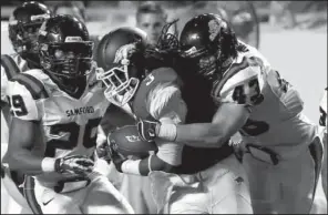  ?? Arkansas Democrat-Gazette/RICK McFARLAND ?? Arkansas running back Alex Collins (3) is wrapped up by a host of Samford defenders, including Josh Killett (43), after a long run Saturday night. Collins averaged 7.2 yards per carry, with his longest carry covering 55 yards.