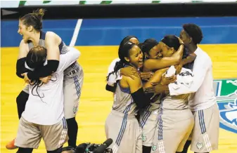  ?? Renee Jones Schneider / Associated Press ?? The Minnesota Lynx, who have been in the WNBA Finals in six of the past seven years, celebrate after outlasting Los Angeles to take the deciding Game 5 of the series.