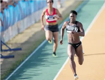  ?? GEOFF ROBINS/AFP/GETTY IMAGES ?? Sprinter Khamica Bingham runs the 100 meters at the Canadian Track and Field Championsh­ips last week. She will race in Edmonton Sunday at the Track Town Classic.